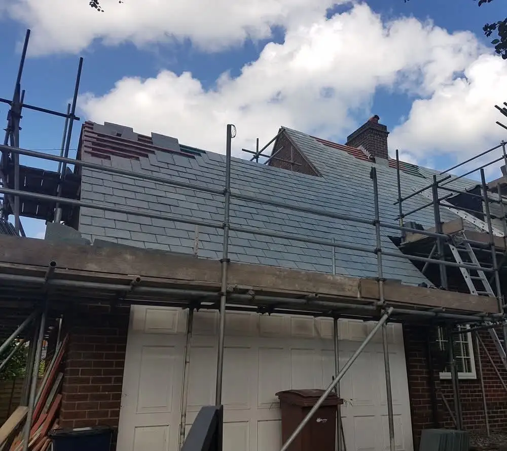 Welsh slate roof installation with scaffolding