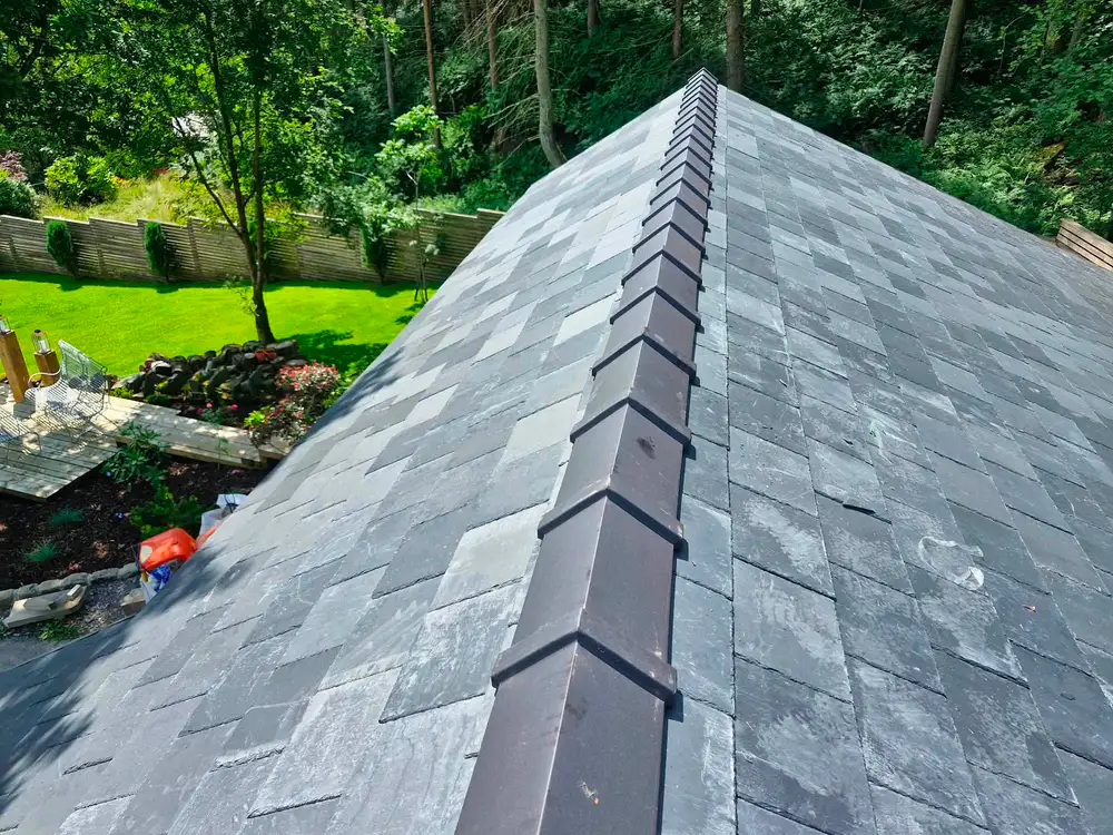 Completed Welsh slate roof and ridge caps